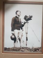 Framed Photo of Tom Blake with camera on tripod.