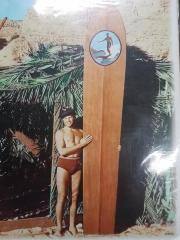 Colorized Photo Print, Man in 1940s era trunks with hat, holding Duke Kahanamoku surfboard.