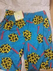 T-Shorts Jams, Drawstring, Soft-cotton, late 80s early 90s blue with black dots and geometric patterns in red and yellow.