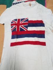 Sandbags Hawaii state flag shirt. White, sewed applique. 
Hackman 1972 in sharpie. (probably misspelled from Hakman)